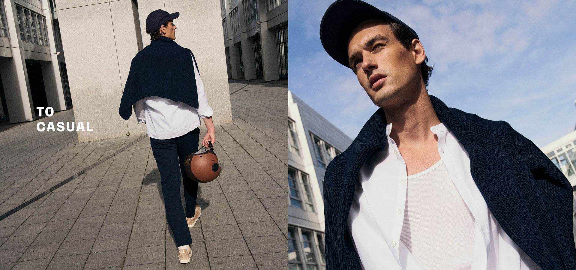 Mann in lässigem TO CASUAL Look mit dunkelblauem Strick, weißem Shirt und Cap, urban inszeniert vor moderner Architektur.