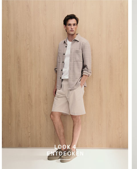 Look 4 entdecken: Our Favourite New Looks: Mann im hellen Sommer Set aus offener Hemdjacke, Shirt und Shorts, lässig vor warmer Holzfläche inszeniert.