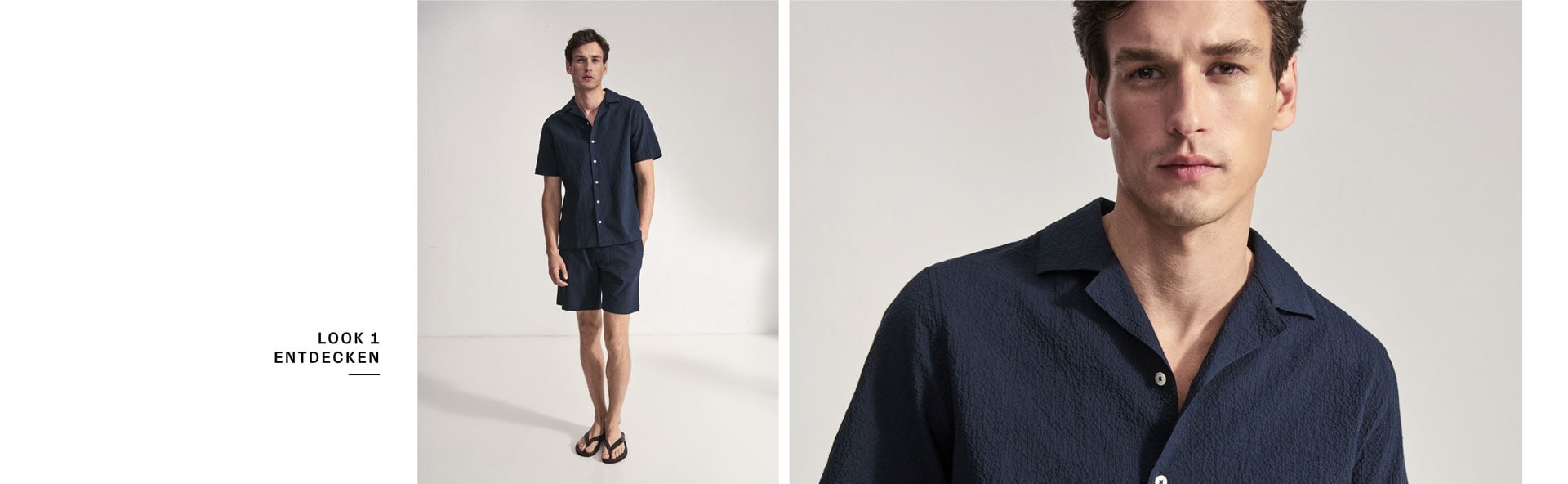 Look 1 entdecken: Our Favourite New Looks: Mann im navyfarbenen Sommer Set aus Kurzarmhemd und Shorts, clean im Studio inszeniert.